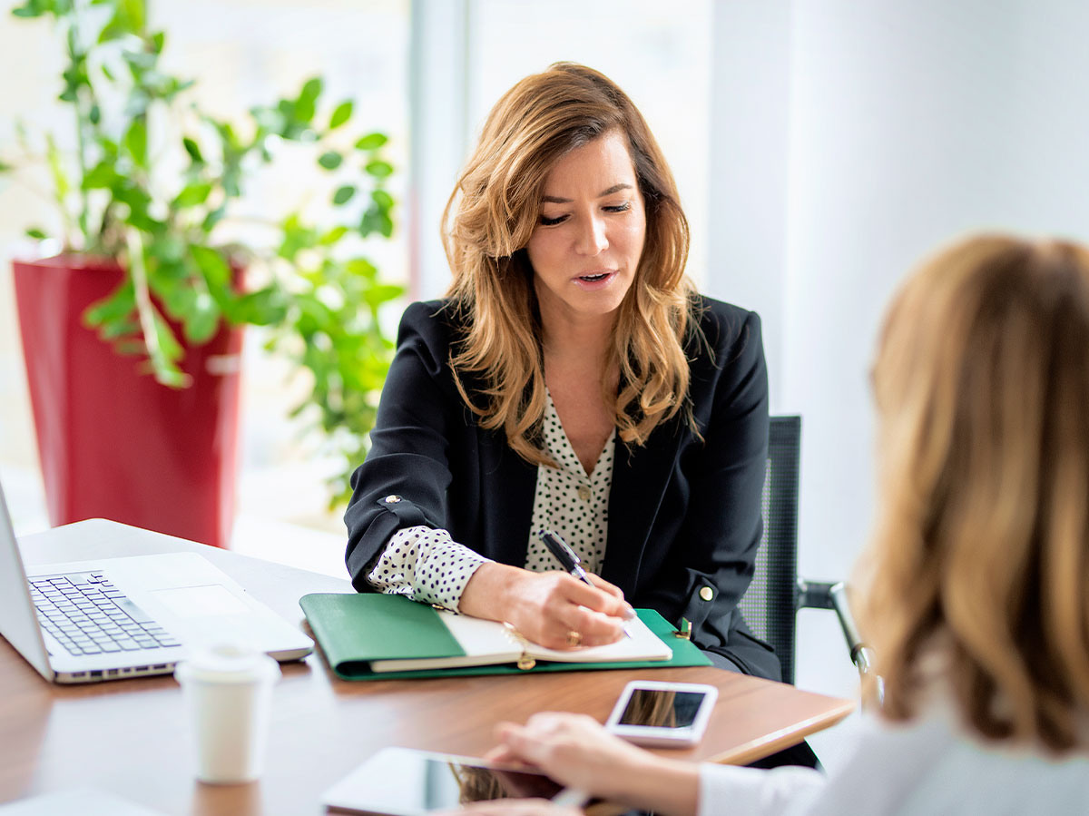 Business woman writing notes