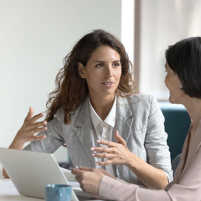 A business woman talking to another woman