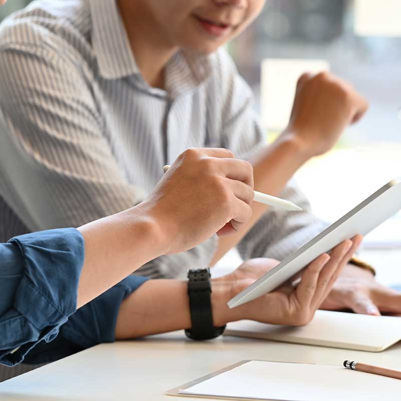  A man pointing to a tablet